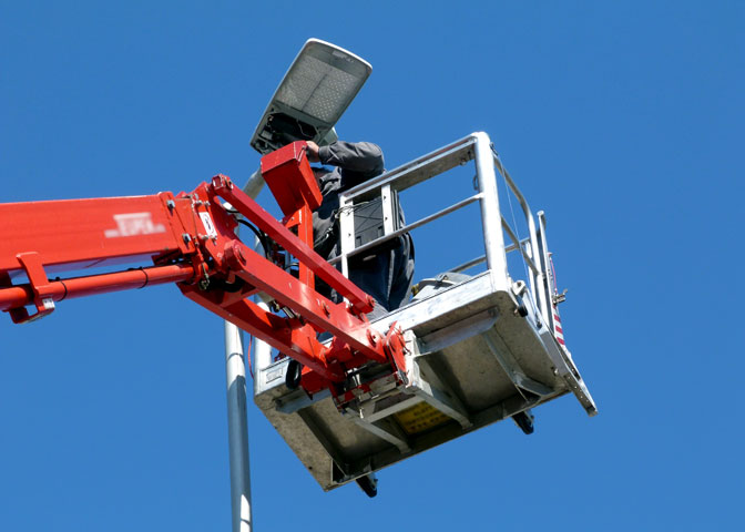 man changing parking lot light