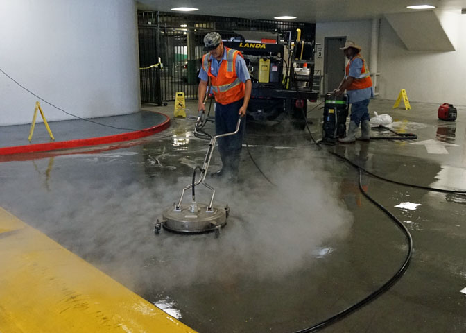 using a surface cleaner to steam clean a parking structure and recovering wash water